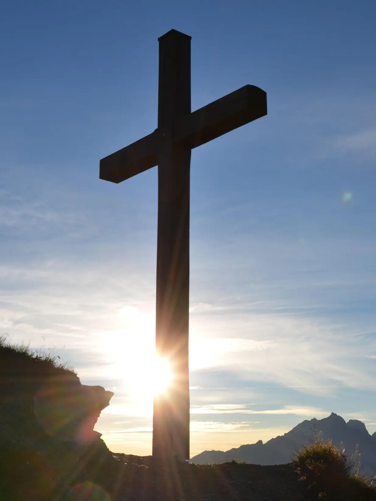large cross with sun behind it at Lakeland Baptist Church in Iron River, Michigan